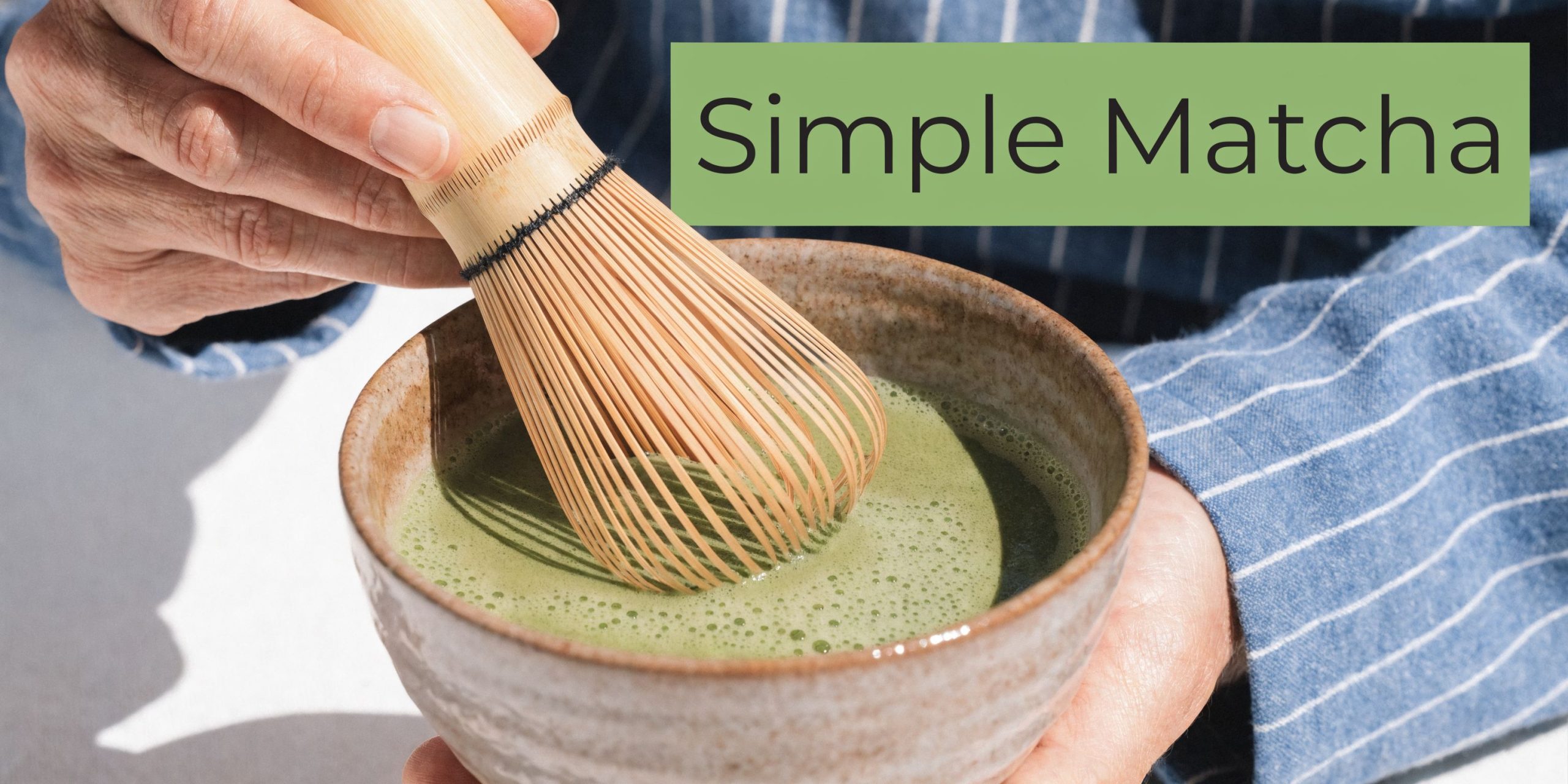 A person whisking a bowl of vibrant green matcha tea using a traditional bamboo whisk.