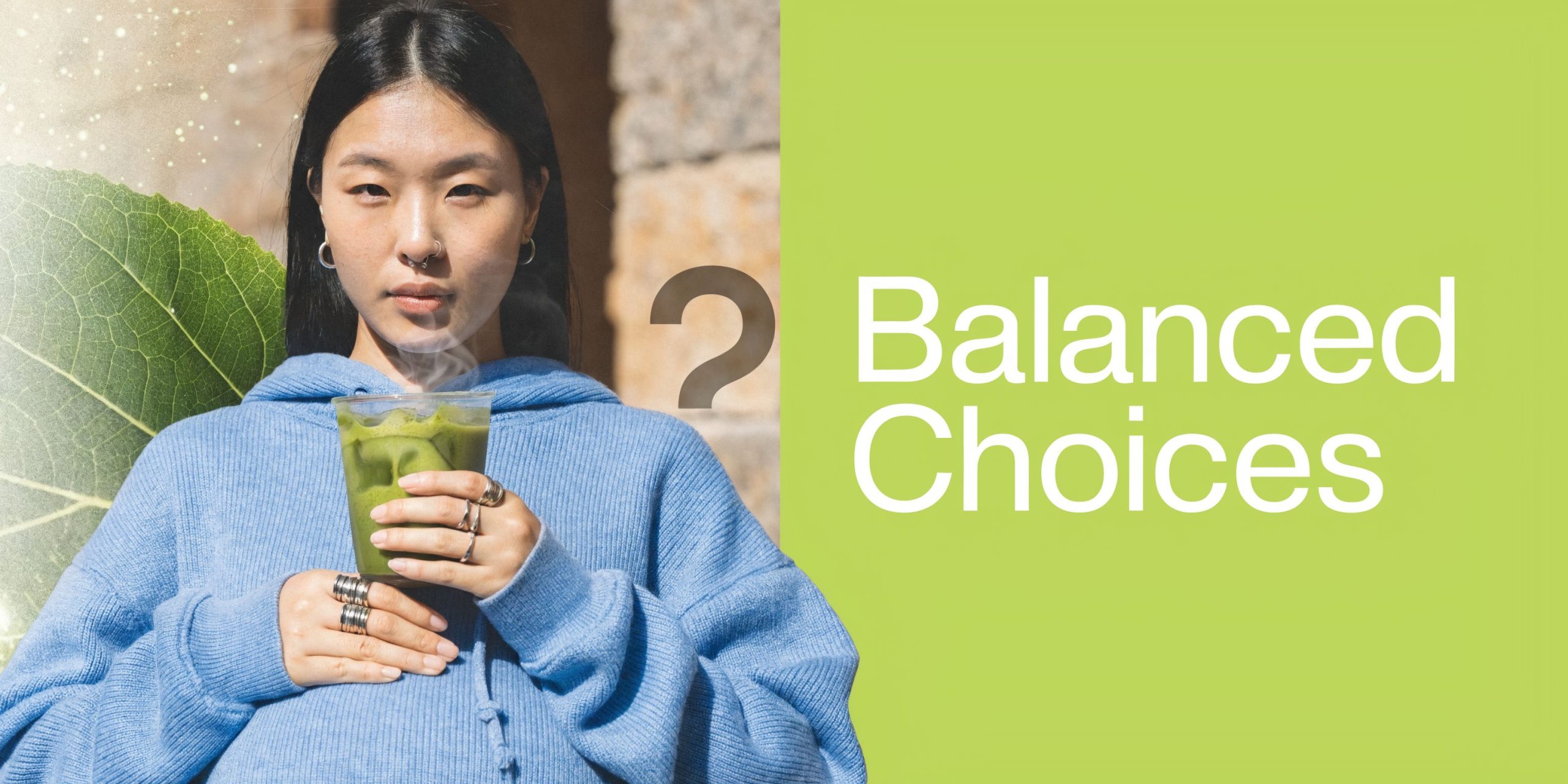 A young pregnant woman holding a cup of steaming matcha tea against a light green background.