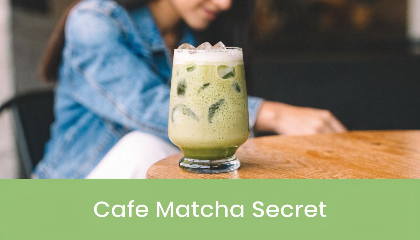 A refreshing iced matcha latte served in a glass on a wooden table at a cafe.