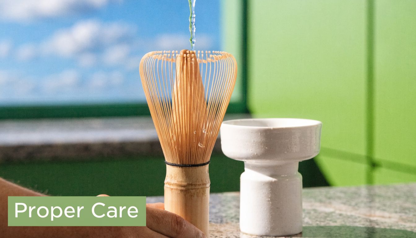 A hand rinses a bamboo matcha whisk with water next to a white ceramic whisk holder.
