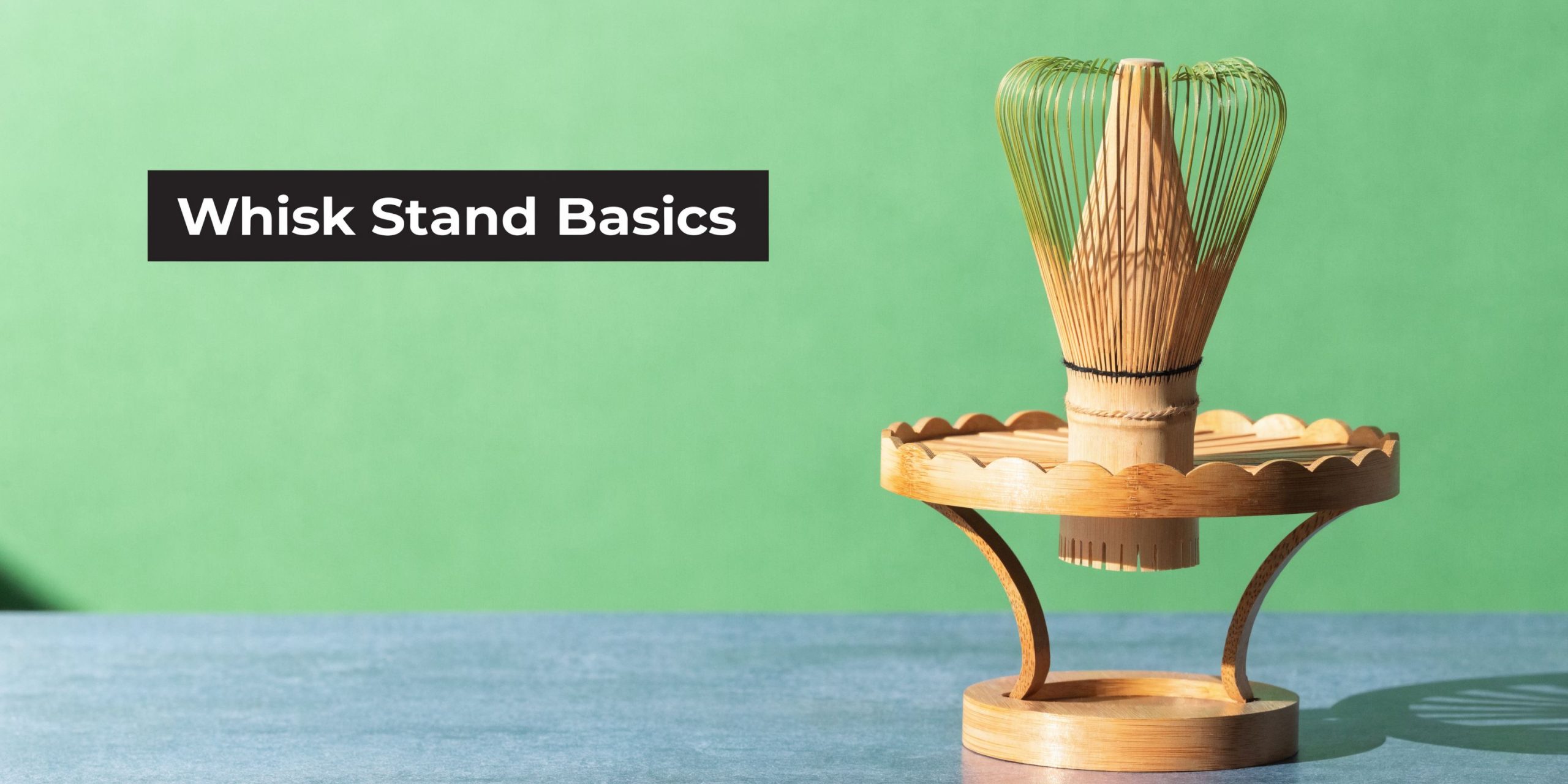 A bamboo matcha whisk resting on a decorative wooden stand against a vibrant green background.