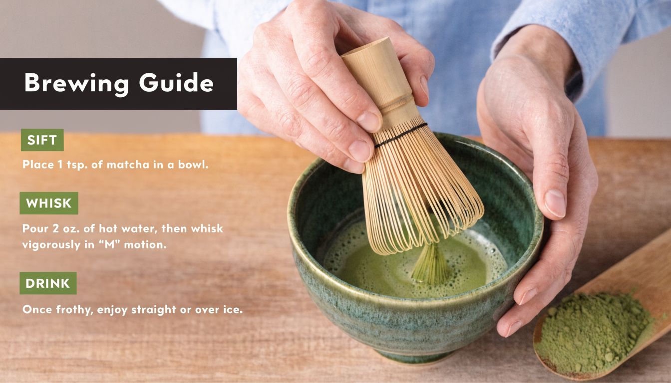 A close-up view of hands using a bamboo whisk to mix matcha powder in a ceramic bowl.