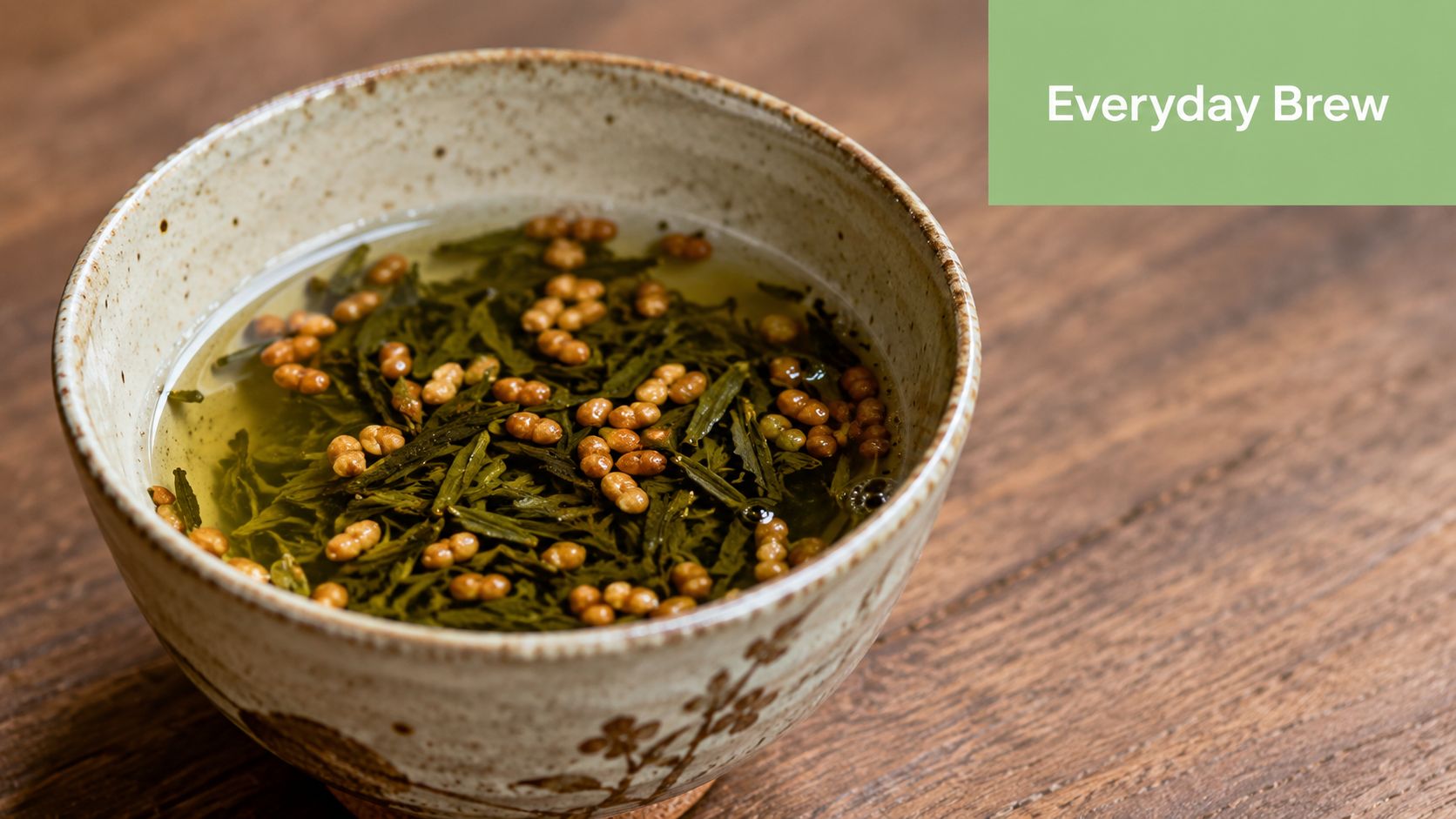 A ceramic bowl filled with green tea leaves and toasted brown rice, known as Genmaicha tea.