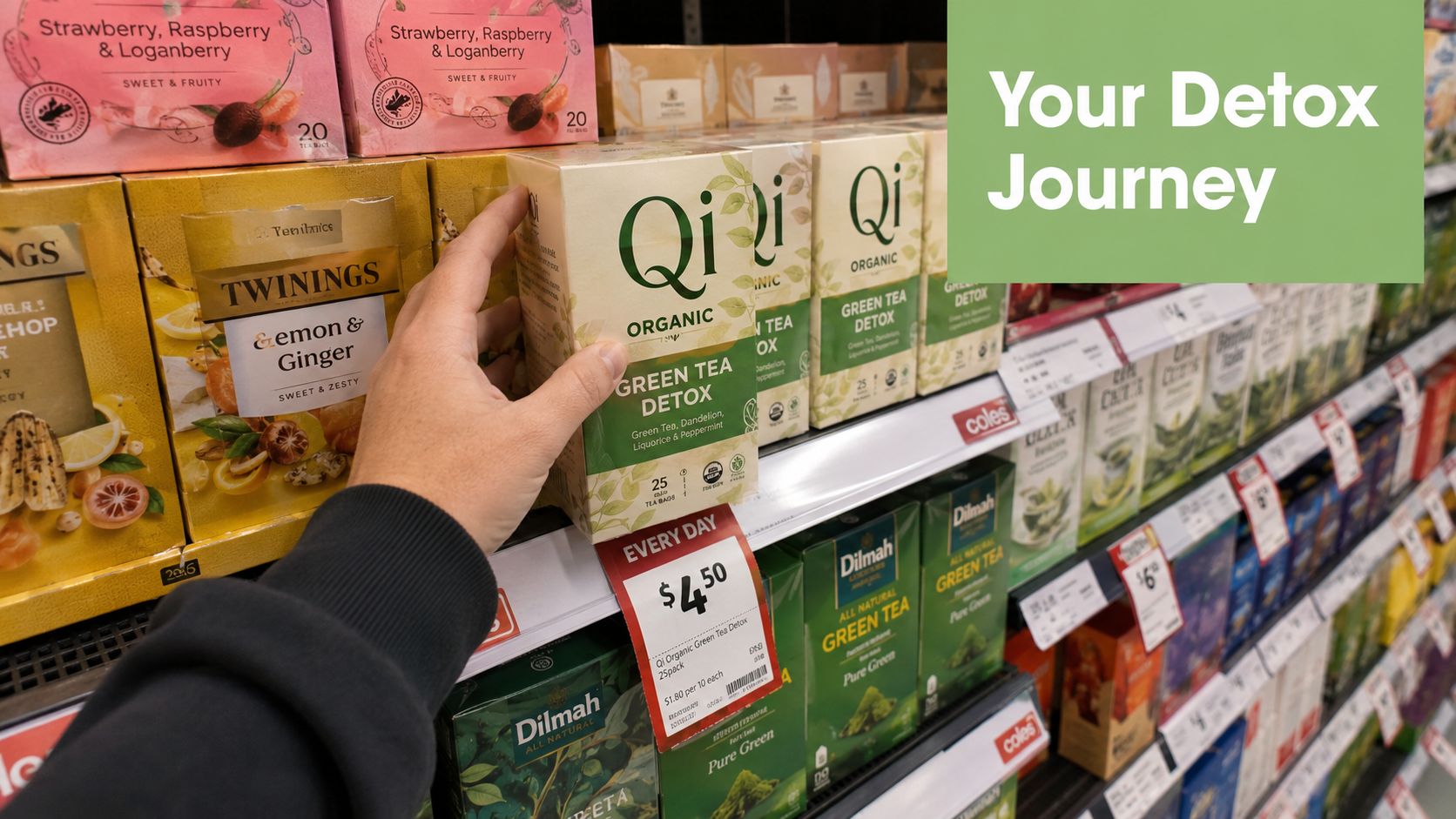 A hand reaching for a box of Qi Organic Green Tea Detox at a Coles supermarket shelf.