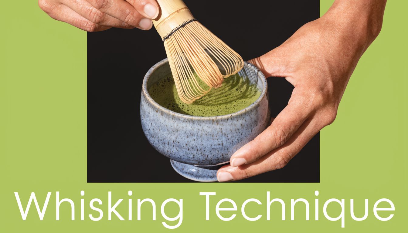 A pair of hands whisking green matcha tea in a ceramic bowl using a bamboo chasen whisk.