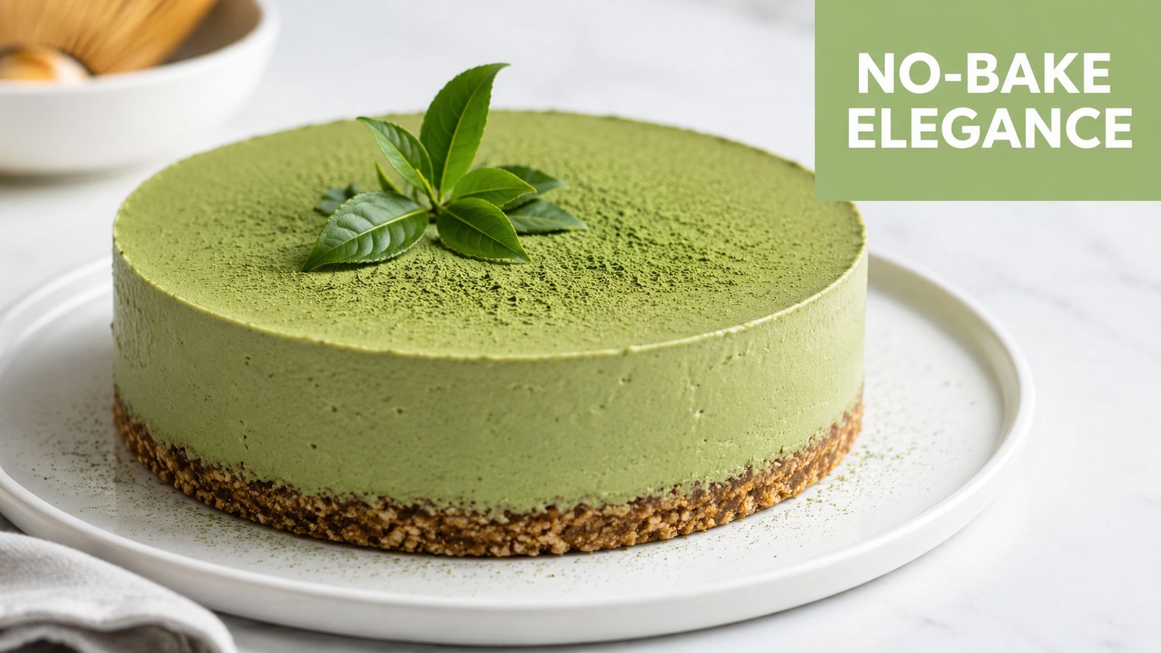 A creamy, round matcha cheesecake topped with fresh green tea leaves on a white plate.