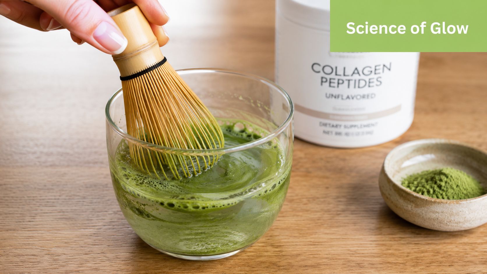 A hand using a wooden bamboo whisk to mix matcha green tea in a glass cup.