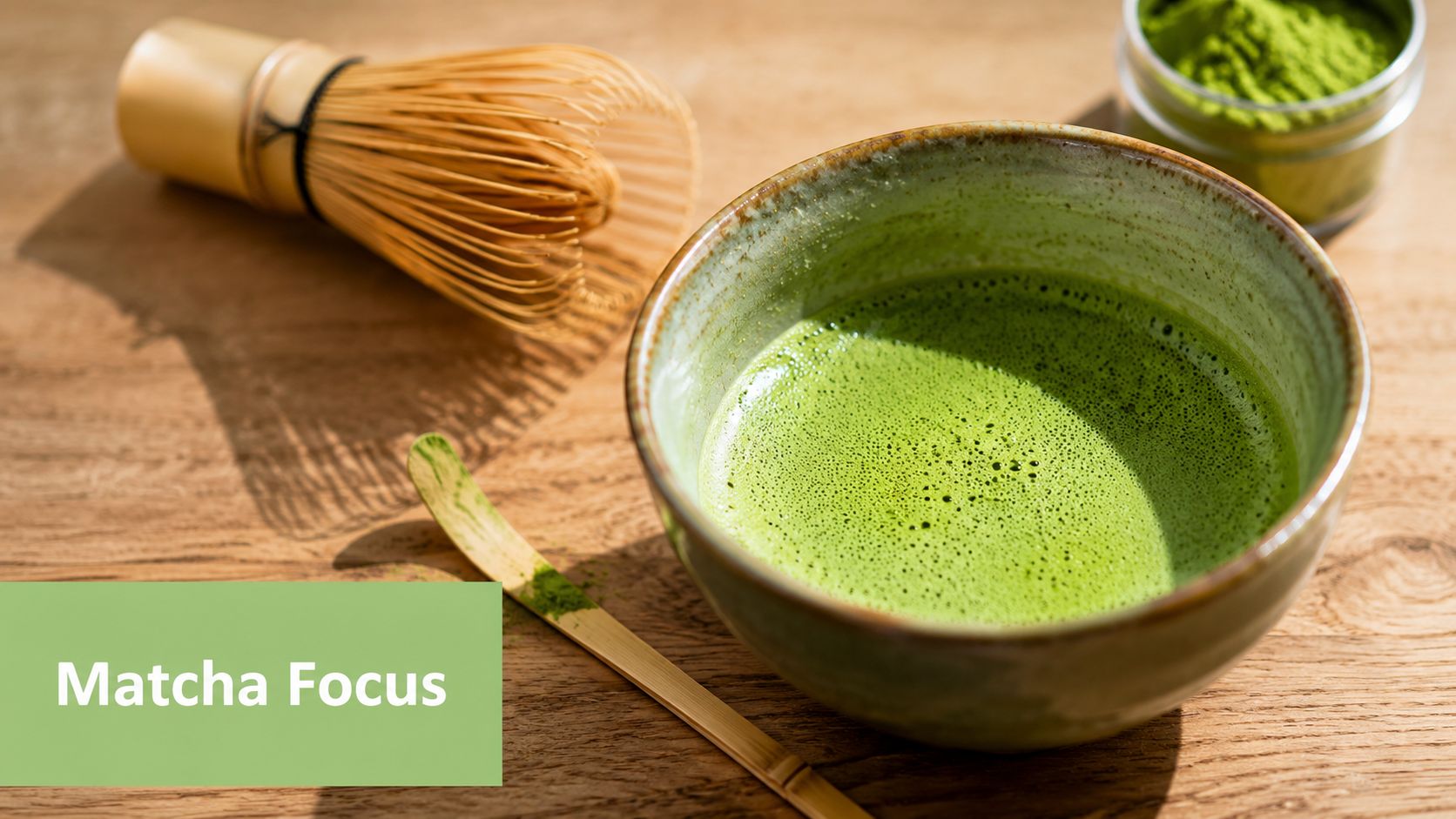 A ceramic bowl filled with vibrant green matcha tea, accompanied by a bamboo whisk and powder.