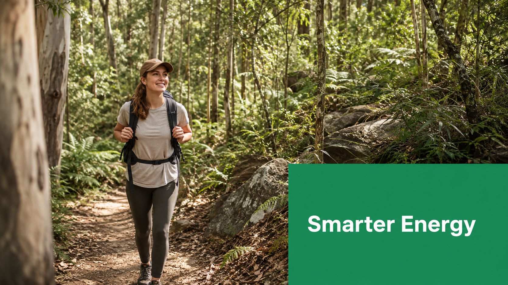 A smiling woman wearing a backpack hiking along a sunny forest trail on a nature walk.
