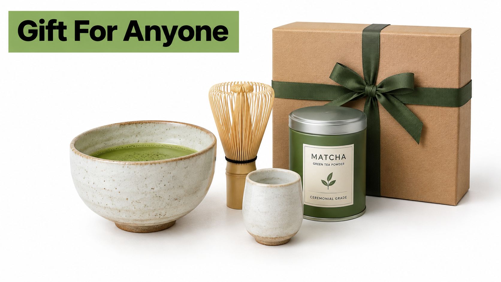 A premium matcha tea gift set featuring a bowl of matcha, bamboo whisk, cup, and tea tin.