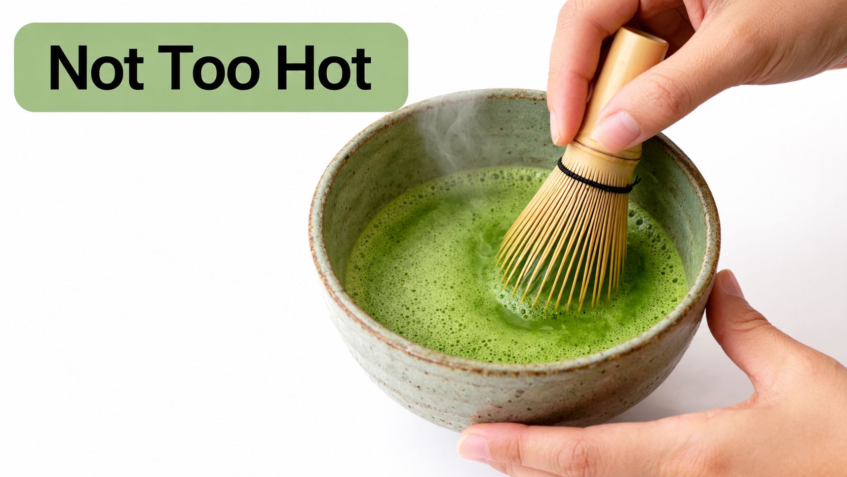 A close-up view of a person whisking matcha tea in a ceramic bowl with a bamboo whisk.